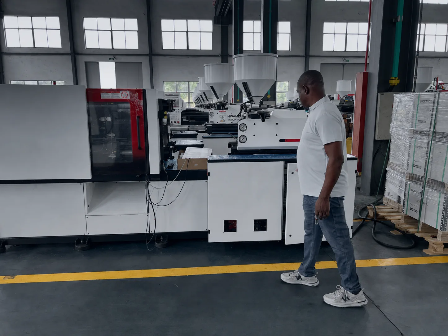 Inspection of a HWAMDA injection molding machine on the factory floor